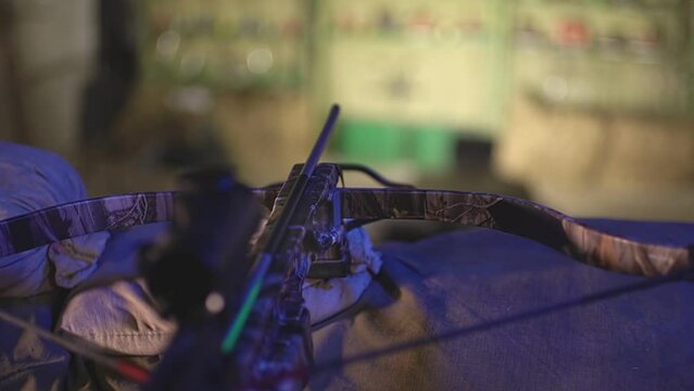 on the table lies a crossbow with an arrow, and in the foreground there are targets for shooting at them. High-quality Full HD video recording. slow motion video