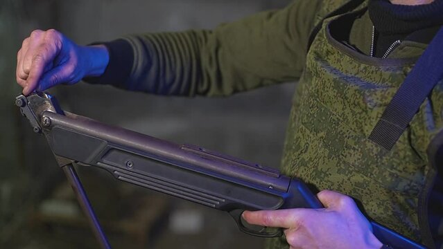 a military man loads an air rifle. High quality Full HD video recording. slow motion video