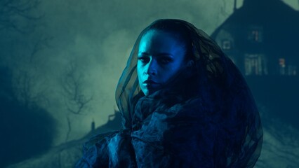 Fototapeta premium Beautiful witch making the witchcraft over the smoky background at night. Scary house on the hill. Halloween image.