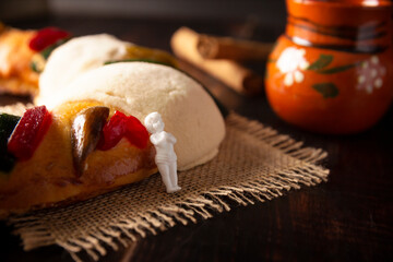 Traditional Kings day cake also called Rosca de Reyes, roscon, Epiphany Cake and with a clay...
