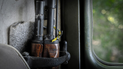 Kalashnikov assault rifle with yellow and blue ribbon.  Russia's military aggression against Ukraine