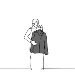 man leaned against his jacket for fitting - one line drawing vector. the concept of buying and trying on a jacket in a store