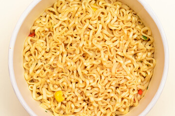 Instant Noodles in Disposable Cup on White Background - Top View. Asian Fast Food. Quick Lunch