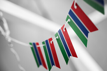 A garland of Gambia national flags on an abstract blurred background