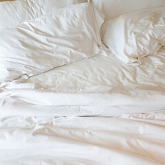 white pillows on crumpled bed