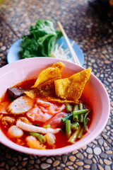 Close up of noodle in pink broth ( Yentafo ) - delicious and healthy street food in Thailand