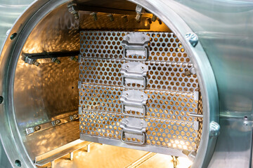 Obraz na płótnie Canvas Stainless steel mesh basket placed in room automatic autoclave retort sterilization in food industry for manufacturing process
