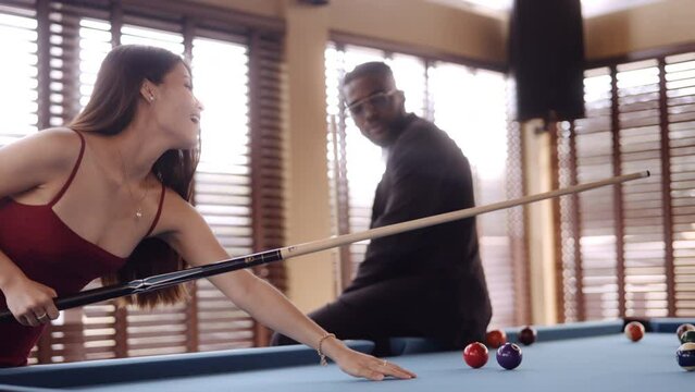 Man Observing The Woman Taking A Pool Shot