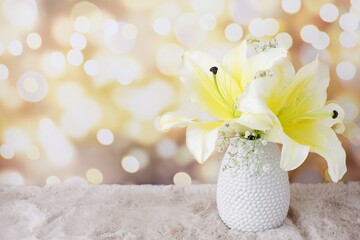 lilies flower in white vase on bokeh background © FON's Fasai
