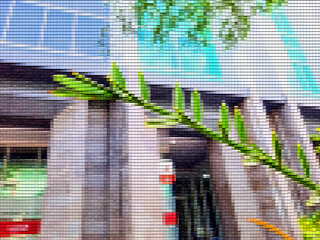 Abstract patchwork background, in it appears a pattern that resembles a leaf against the background of a large building.