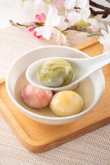 Colored glaze style big tangyuan with cherry blossom flower and syrup soup.