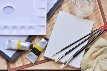 acrylic painting brush and blank canvas 