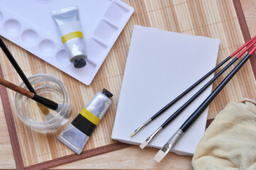 acrylic painting brush and blank canvas 