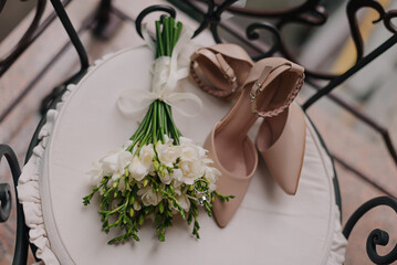 Wedding rings with shoes and flowers