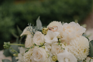 White wedding bouquet with wedding rings