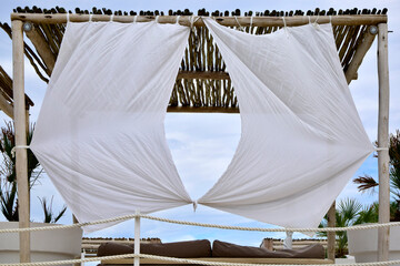 Beach bar exterior with wooden tent and white canvas © drobacphoto