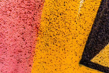 colorful background of graffiti in a city with bright aerosol strips and beautiful colors , urban school wall backdrop