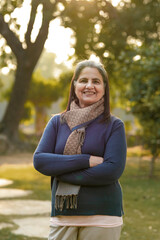 Indian woman in winter wear standing at park