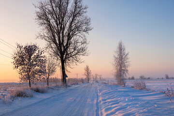 Real winter, snow-covered road, beautiful light, frosty morning