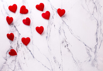 Valentines day background . Romantic  layout. Red hearts on  white marble background.  Top view. Place for text.