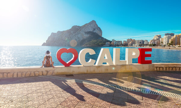 Calpe city and woman tourist- beach, rock and city landscape, Spain- Costa blanca