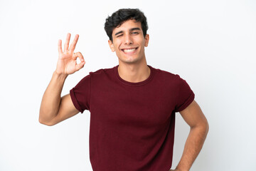 Fototapeta premium Young Argentinian man isolated on white background showing ok sign with fingers