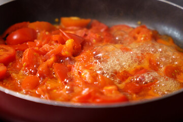 Freshly made tomato juice is boiled in a saucepan. Diet concept for a healthy lifestyle.