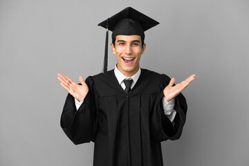 Young Argentinian university graduate isolated on grey background with shocked facial expression