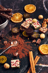 a variety of chocolates on a dark background