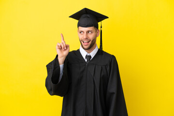 Young university graduate caucasian man isolated on yellow background intending to realizes the solution while lifting a finger up