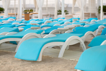 rows of sun loungers on the beach, luxury seaside vacation
