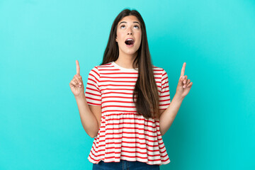 Young Brazilian woman isolated on blue background surprised and pointing up