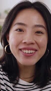POV happy young asian woman having a video call through smartphone network app at home. Cheerful chinese female talking on videoconference by cellphone - High quality 4k footage