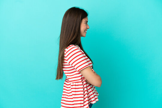 Young Brazilian woman isolated on blue background in lateral position