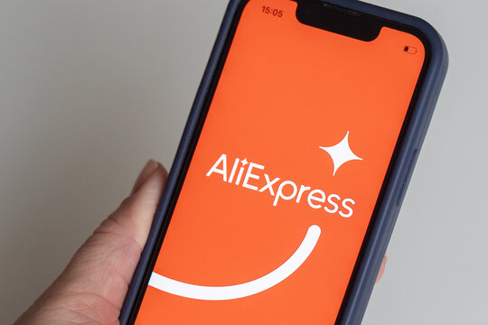 AliExpress app, Aliexpress logo on the screen of the iphone in female hand, Georgia, Batumi, December 6, 2022