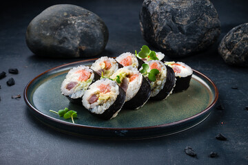 Sushi rolls set with tuna, salmon, Philadelphia cheese, avocado and microgreens.