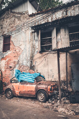 Fototapeta na wymiar Broken car park in old slum village in Bangkok