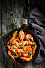 Tasty and spicy shrimps on pan with garlic and coriander.