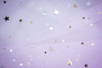 Light pink Crumpled festive tulle fabric (pink, purple, delicate) with sequins in the form of stars...