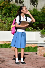 Cute Asian School Girl Yelling Wearing Bookbag With School Books Standing