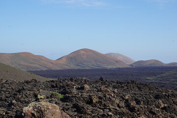 Fototapeta na wymiar Different shapes of volcanic lava which solidified on Lanzarote Island 200 years ago, rocks, lava, photographed in November 2022, lava chimney, lava tunnel