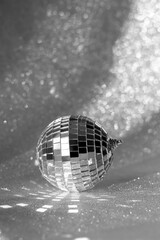 Disco ball and bokeh background. Christmas concept. Mirror ball on the Christmas tree for the new year.