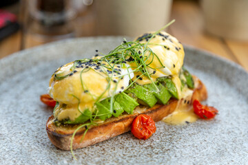 Poached eggs and avocado toast on the plate, healthy breakfast option