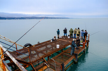 Obraz na płótnie Canvas Fishing at Cape Pitsunda on the Black Sea coast in Abkhazia in winter