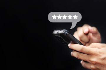 close up on customer man hand pressing on smartphone screen with gold five star rating feedback icon and press level excellent rank for giving best score point to review the service