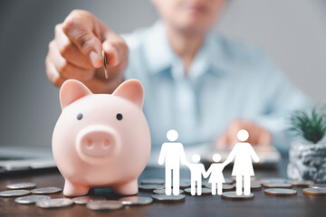 Businesswoman take a position to protect on the piggybank and paper family in hand, donation,...