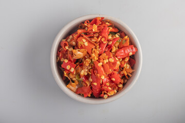 Freshly ground red chilies in a white cup