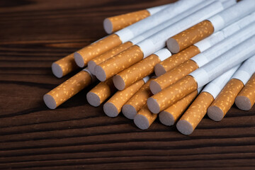 heap of cigarette on a wooden background