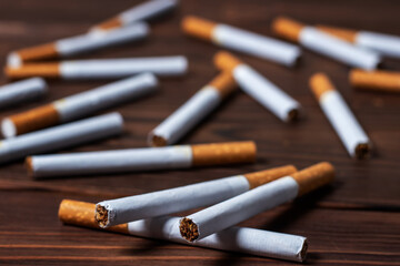 image of several commercially made cigarettes. pile cigarette on wooden. or Non smoking campaign concept, tobacco