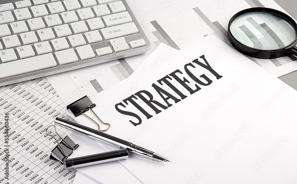 Poster strategy text on paper with chart and keyboard, business concept